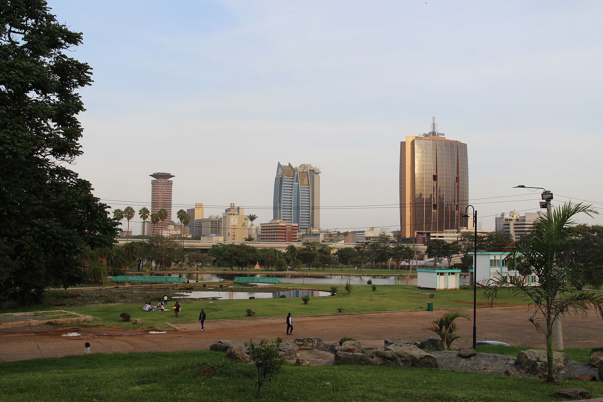 Nairobi skyline seen across Uhuru Park, with the KICC tower and office blocks beyond the pond